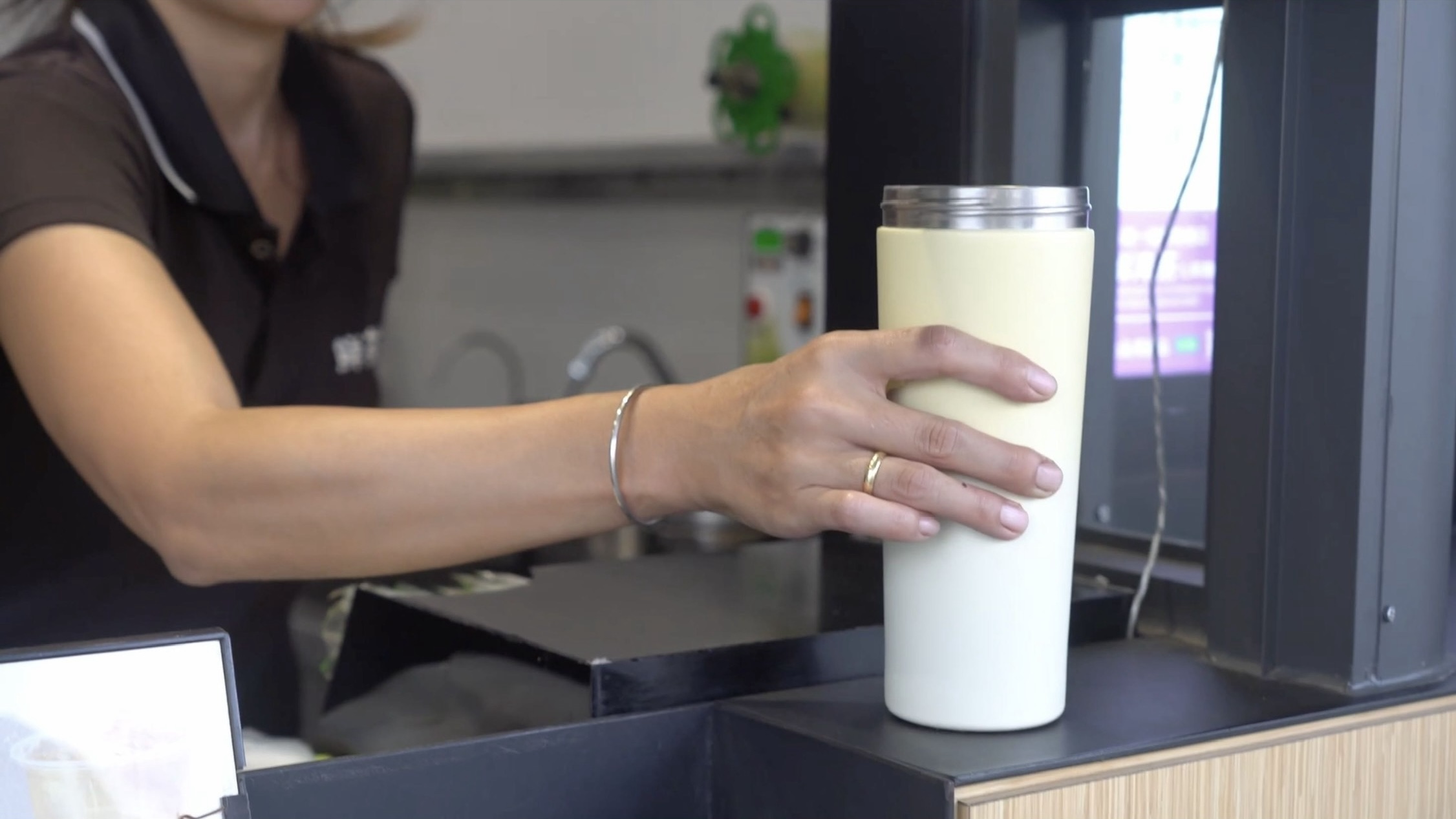 飲料店店員手上拿著一個白色環保杯